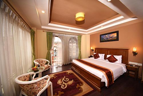 a hotel room with a bed and a window at DOM Himalaya Hotel in Kathmandu
