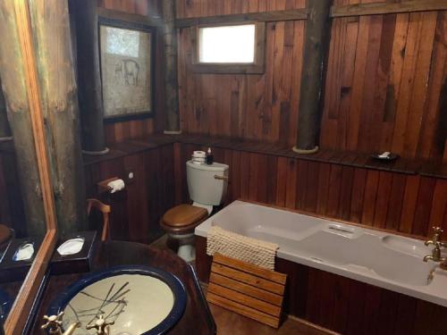 a bathroom with a bath tub and a toilet at Shayamoya Tiger Fishing and Game Lodge in Pongola Game Reserve