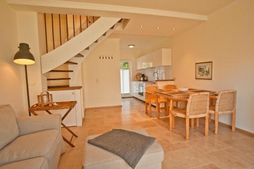 a kitchen and living room with a table and chairs at Ferienhäuser Südwind in Hiddensee