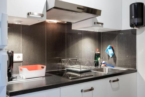 a kitchen with a sink and a counter top at EttSmart Hotell in Sollentuna