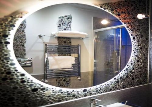a bathroom mirror with a sink and a towel at Opera House Guest, Roma centro storico in Rome