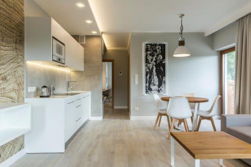 a kitchen and dining room with a table and chairs at Royal Hill Residence in Zakopane