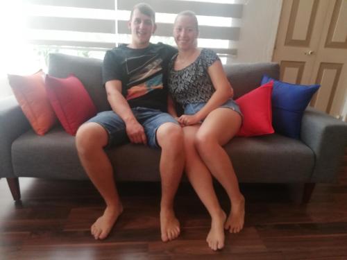 a man and a woman sitting on a couch at Eden Studio Apartments - 1 in Colombo