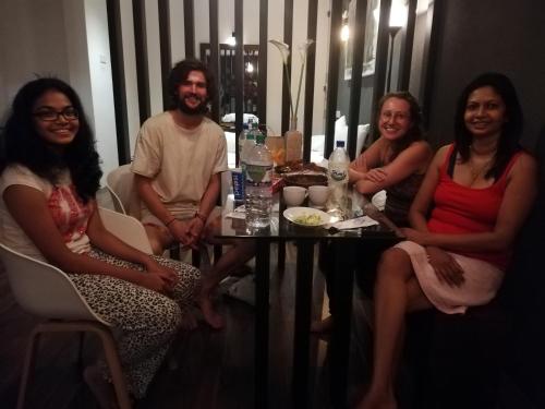 a group of people sitting around a table at Eden Studio Apartments - 1 in Colombo