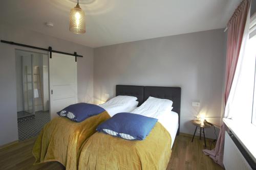 a bedroom with a bed with two pillows on it at Brimslóð Atelier Guesthouse in Blönduós