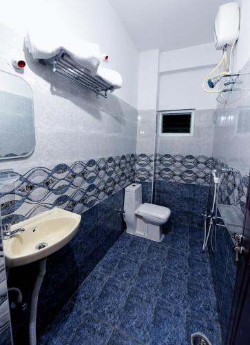 a bathroom with a toilet and a sink at Sree Service apartments in Tirupati