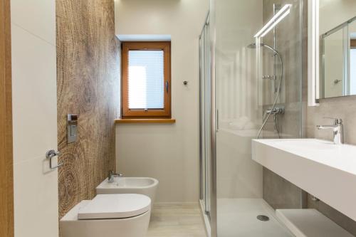 a bathroom with a toilet and a sink and a shower at Royal Hill Residence in Zakopane