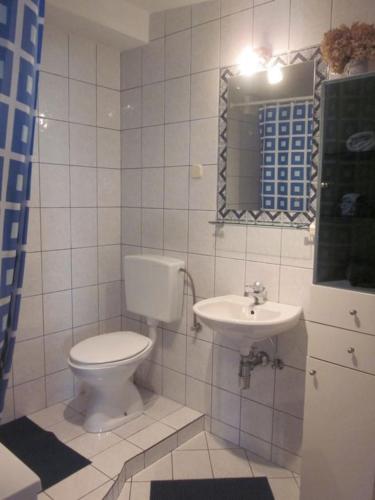 a bathroom with a toilet and a sink at grabrova cove in Novi Vinodolski