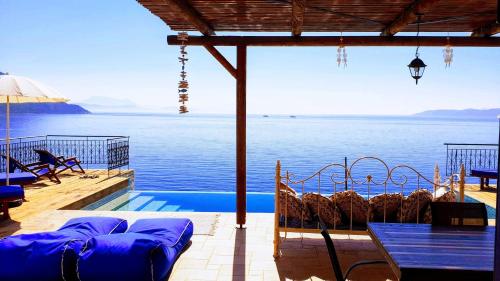 a resort with a pool and a view of the water at Villa LeSunLuka Lefkada in Vasiliki
