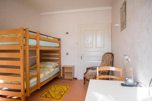 a small room with a bunk bed and a desk at La Caquerelle in Col des Rangiers