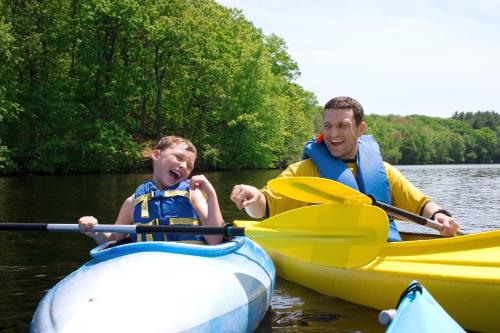 a man and a boy in a kayak on the water at Golden Lakes Hotel in Boussu-lez-Walcourt