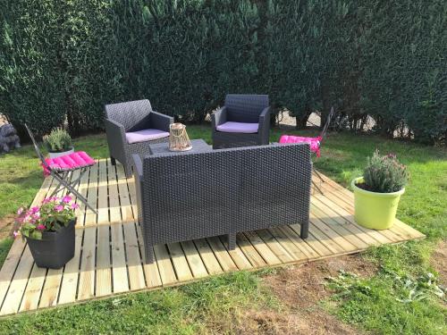 a wooden deck with two chairs and a table and two chairs at Ferme de la Petite Fagne in Spa