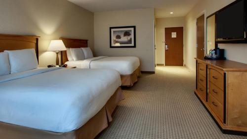 a hotel room with two beds and a flat screen tv at Hollywood Casino Bangor in Bangor
