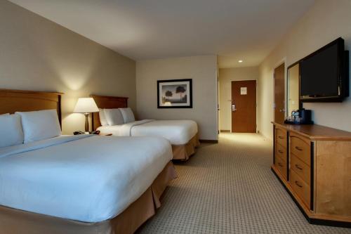 a hotel room with two beds and a flat screen tv at Hollywood Casino Bangor in Bangor
