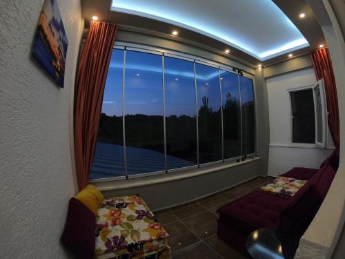 a room with a large window with a view of the water at PASHA APART~BOUTİQUE HOTEL/YALOVA in Yalova