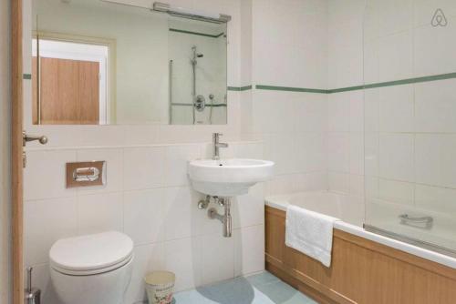 a bathroom with a toilet and a sink and a tub at Kelston South Dublin in Dublin