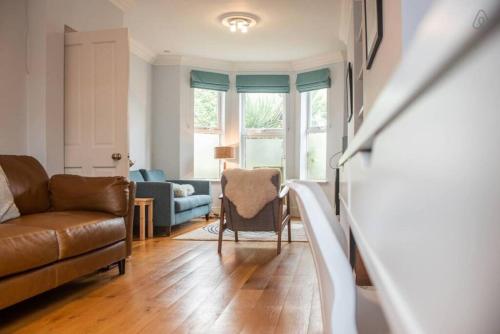 a living room with a couch and a chair at Rugby Lodge in Dublin