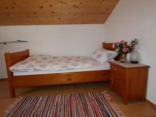 a bedroom with a bed and a table with flowers on it at Ferienwohnung Pfnür in Berchtesgaden