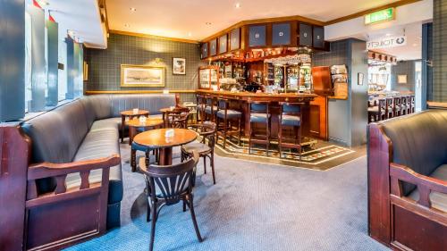 a restaurant with couches and tables and a bar at The Bosun in Monkstown