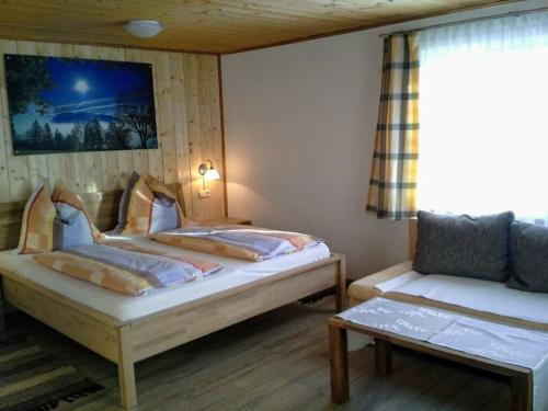 a room with two beds and a couch in it at Bunzbauernhof in Bad Mitterndorf