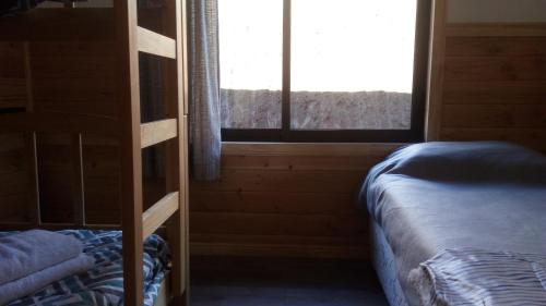 a bedroom with a bunk bed and a window at Cabañas Mirador Lago Ranco in Lago Ranco