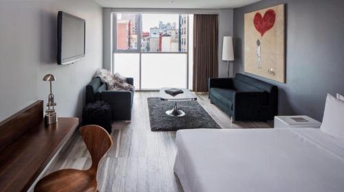 a hotel room with a bed and a living room at Hotel on Rivington in New York