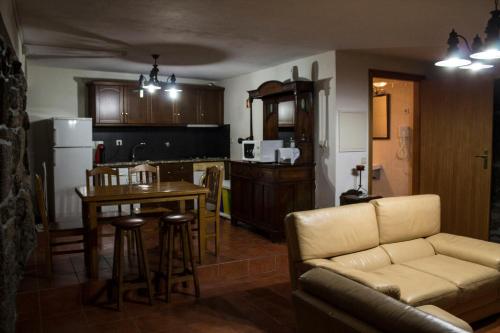 a living room and kitchen with a couch and a table at Quinta Do Meira in Braga