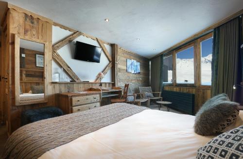 a bedroom with a bed and a tv at Hotel Des 3 Vallées Val Thorens in Val Thorens