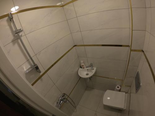 a small bathroom with a sink and a toilet at PASHA APART~BOUTİQUE HOTEL/YALOVA in Yalova