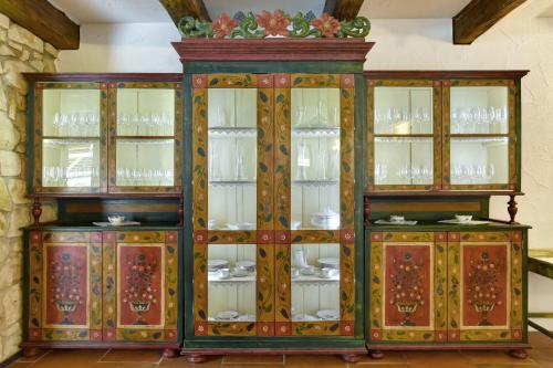 a wooden cabinet with plates and dishes in it at Zamecka Fortovna Obora - Forester House in Kaznějov