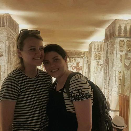 two young women standing in front of a painting at Pyramids Top Inn in Cairo