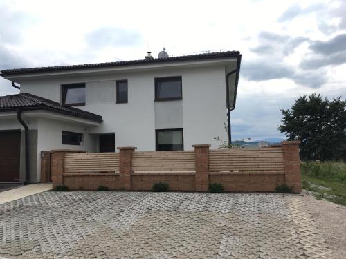 a house with a wooden fence in front of it at Privát in Poprad
