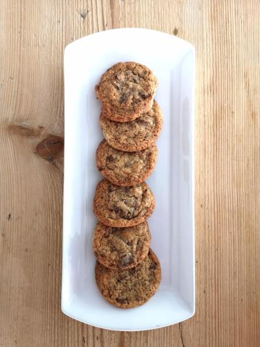 a stack of chocolate chip cookies in a white container at Camina Suite and Spa in Cortina dʼAmpezzo