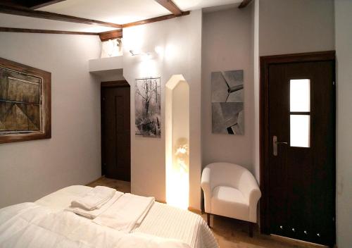 a bedroom with a bed and a chair and a window at Ojców Bazar Lwowski in Ojców