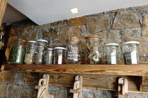 a bunch of glass jars on a stone wall at Hotel 3 Vallées Val Thorens in Val Thorens