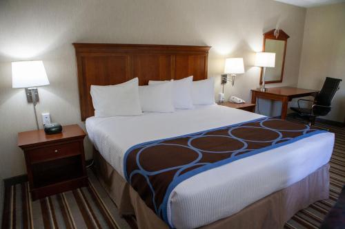a hotel room with a large bed and two lamps at Super 8 by Wyndham Port Elgin in Port Elgin