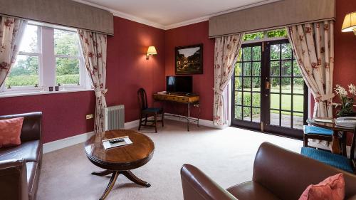 a living room with a couch and a table at Ballathie House Hotel in Perth