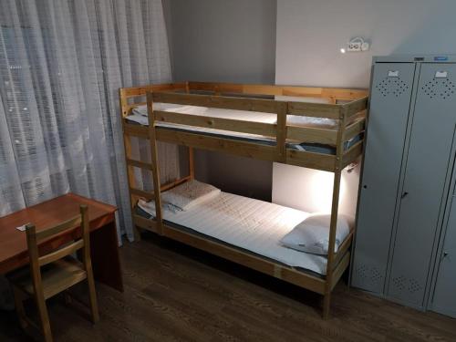 a room with two bunk beds and a desk at The Place Astana Hostel in Astana