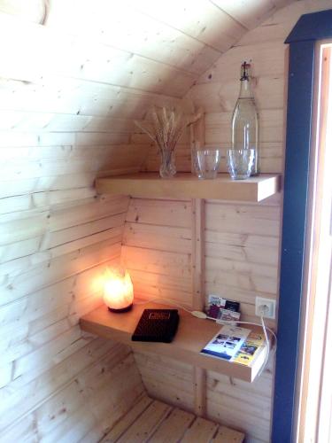 a room with a wooden wall with a desk at LES TONNEAUX DE L'EURE LOGEMENT INSOLITE in Neuilly