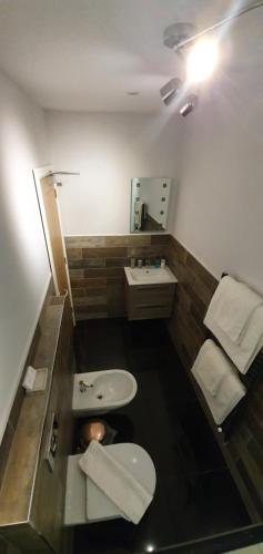 a small bathroom with a toilet and a sink at The Bronze Pig in Lincoln