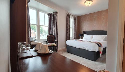 a bedroom with a bed and a large window at The Bronze Pig in Lincoln