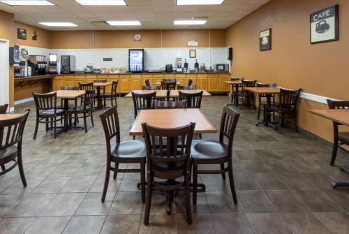 a dining room with wooden tables and chairs at Med City Inn & Suites Rochester Mayo Clinic Area in Rochester