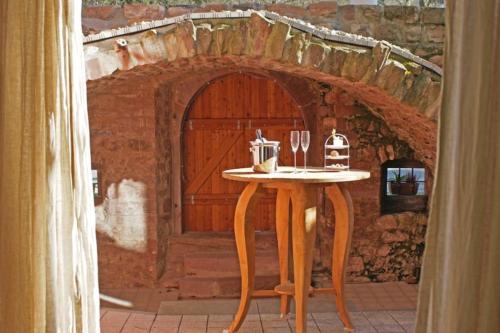 a table in front of a building with a door at Nashira Kurpark Hotel in Bad Herrenalb