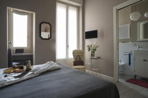 a bedroom with a bed and a sink and a mirror at CasaTitta in Milan