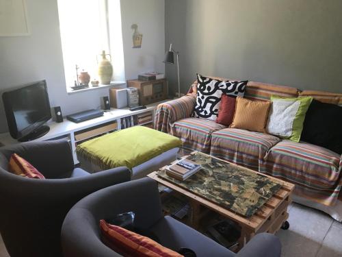 a living room with couches and a coffee table at Aegina's Oasis in Aegina Town