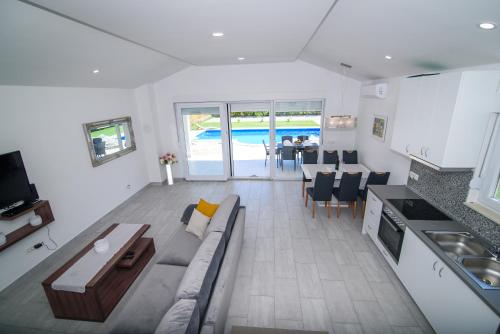 a kitchen and living room with a couch and a table at Villa Mirna in Mostar