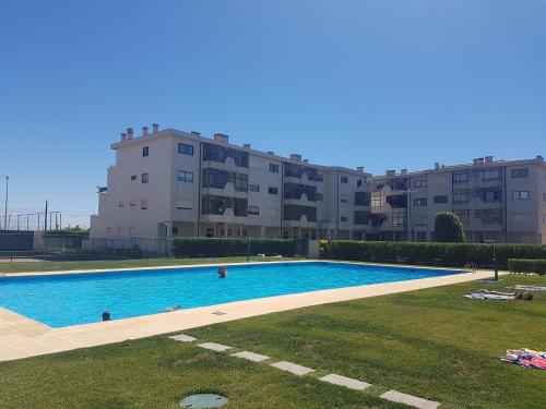 a large swimming pool in front of a building at Sunny Beach Apartment Holidays in Vila do Conde