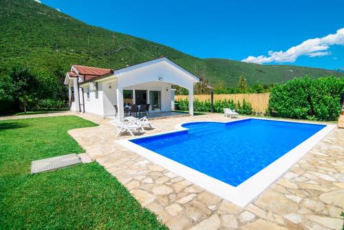 a swimming pool in the backyard of a house at Villa Mirna in Mostar