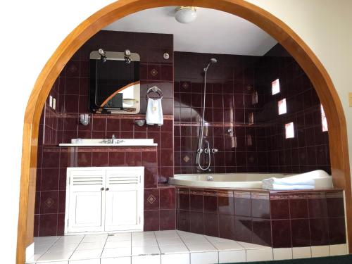 a bathroom with a tub and a sink at Saint Germain Hotel in Trujillo