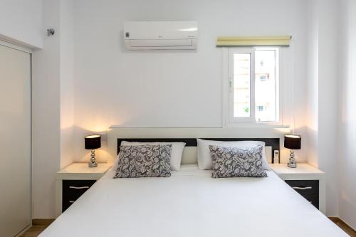 Postel nebo postele na pokoji v ubytování Sonrisa Apartments